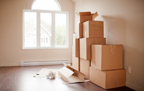 Home removal van loading boxes for a Hampstead move with nearby residential buildings