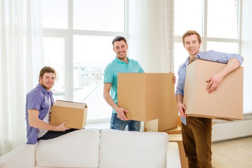 Professional movers handling furniture in a Hampstead flat