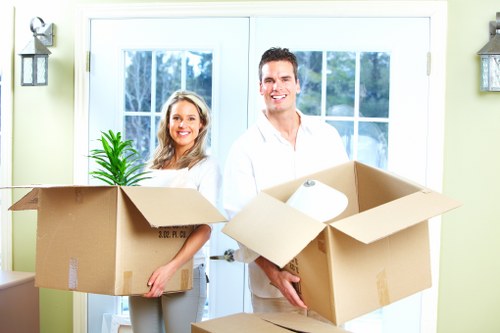 Mover wearing PPE while loading furniture safely into a removal vehicle